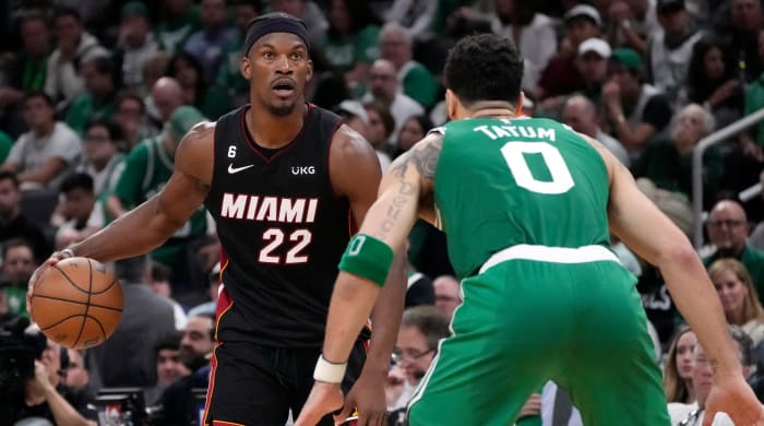 Miami Heat forward Jimmy Butler (left) dribbles as Boston Celtics forward Jayson Tatum defends